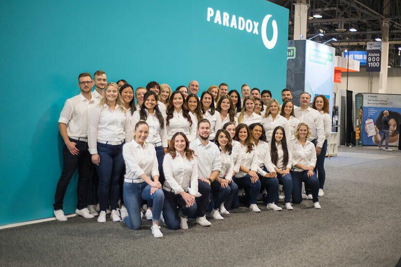 Paradox team members in front of blue wall